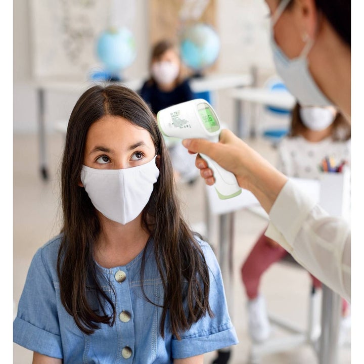 Child getting their temperature taken