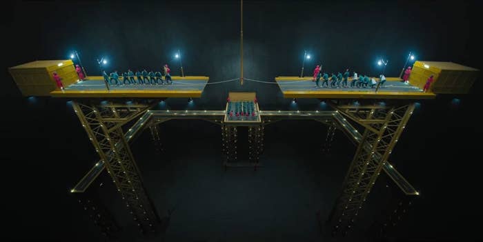 Two platforms are suspended in mid air as two teams tug on a single piece of rope