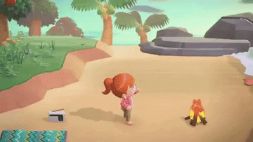 An Animal Crossing: New Horizons character sitting on the beach.