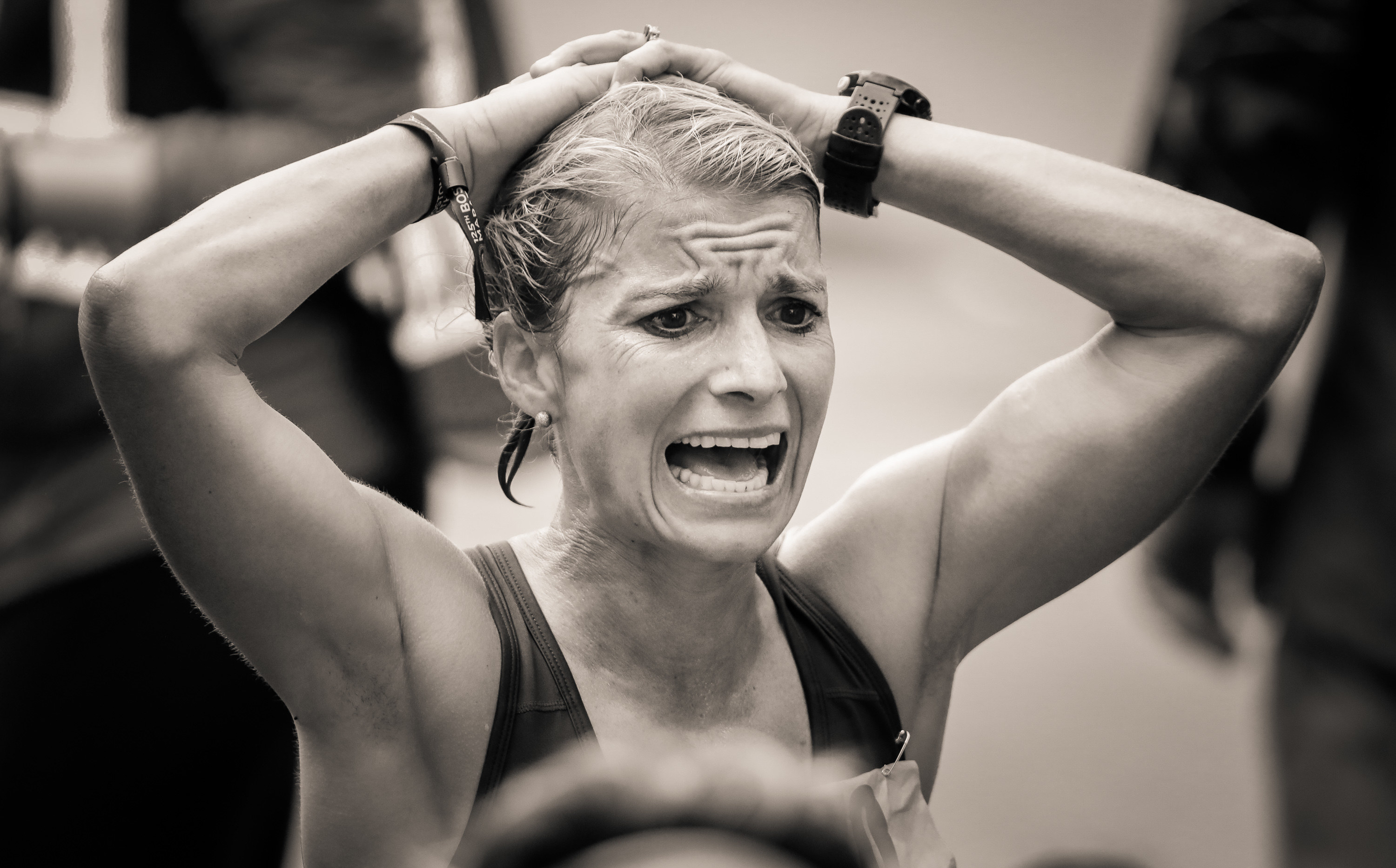 A woman grimaces at the finish line