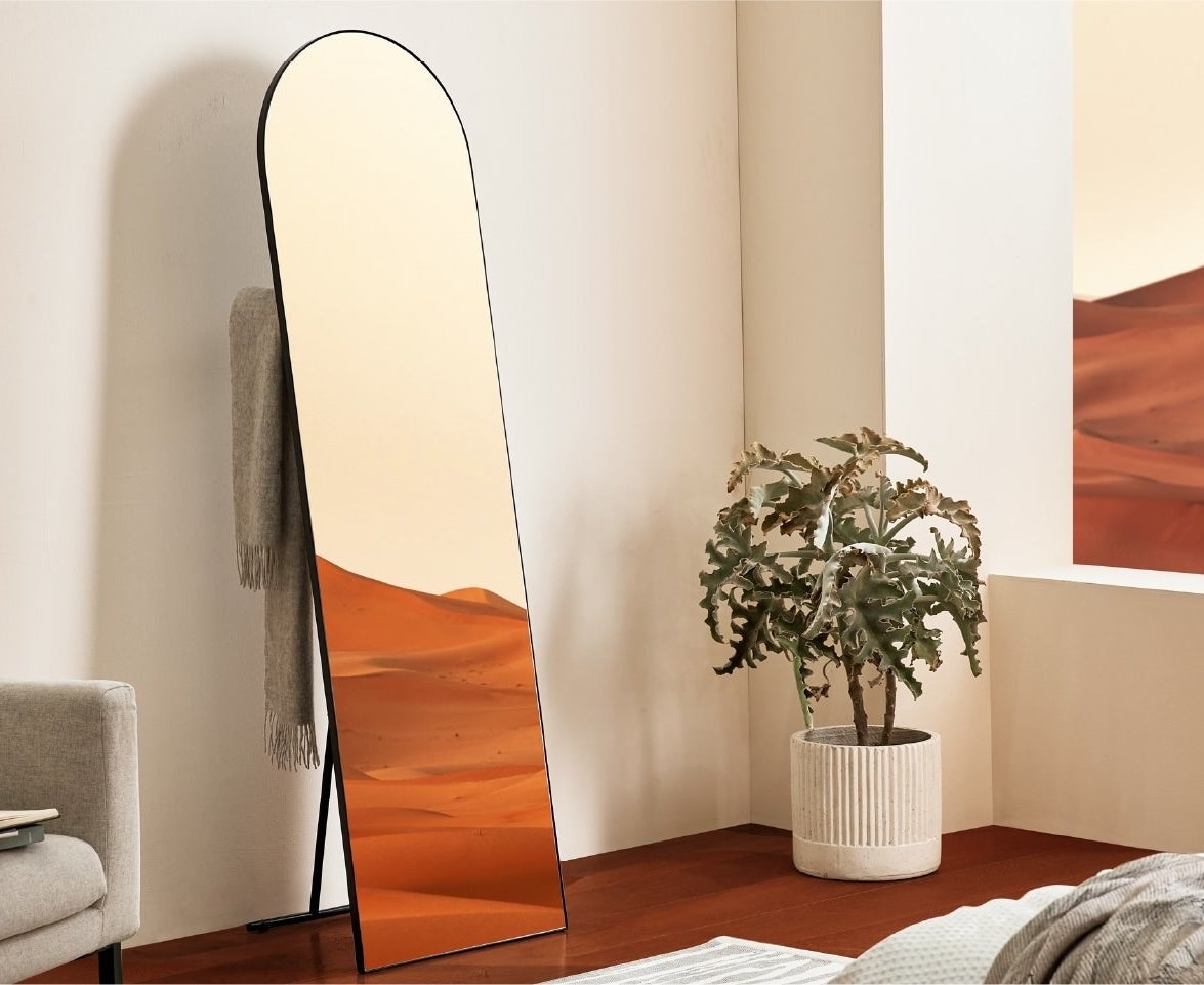 full-length mirror with rounded top and black trim