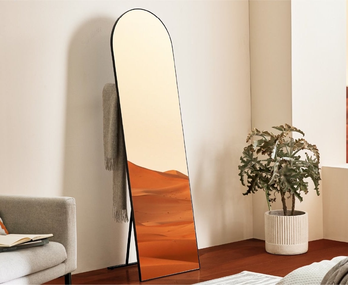 full-length mirror with rounded top and black trim