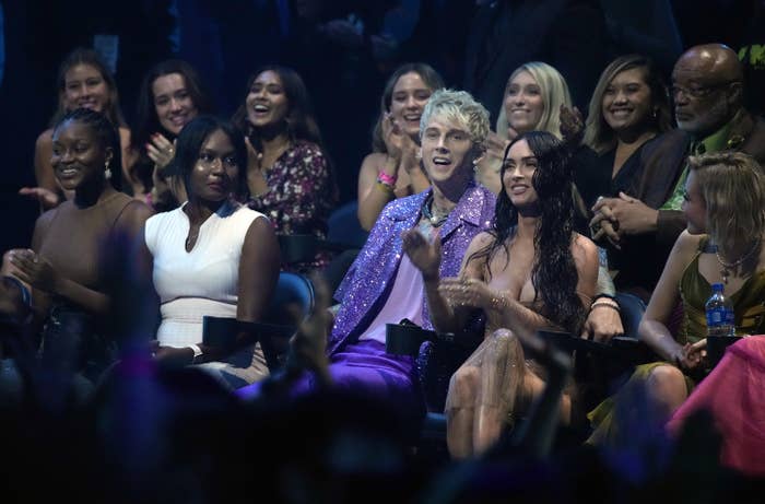 Machine Gun Kelly and Megan sitting next to each other at an awards show