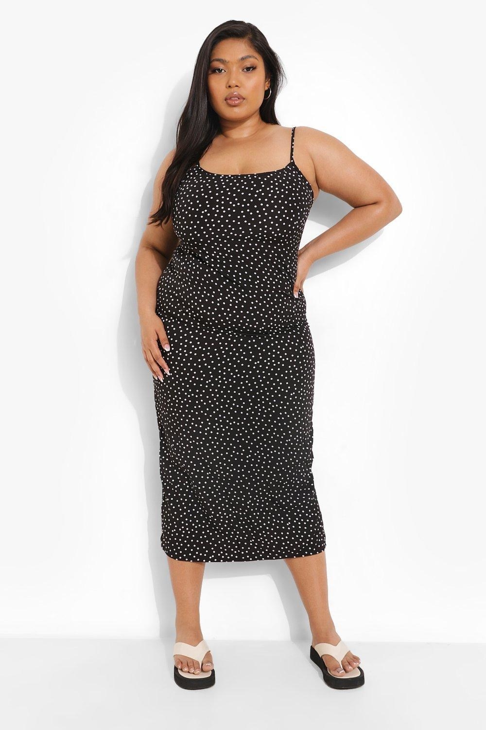 Model wearing black polka dot dress
