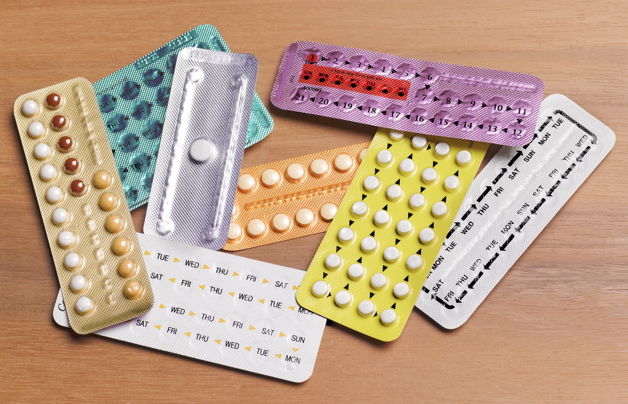 An array of birth control pill packages on a table