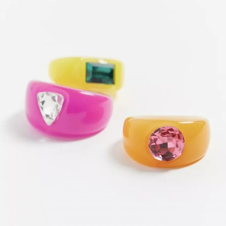 three rings stacked, one in yellow, pink, and orange, all with their respective rhinestones