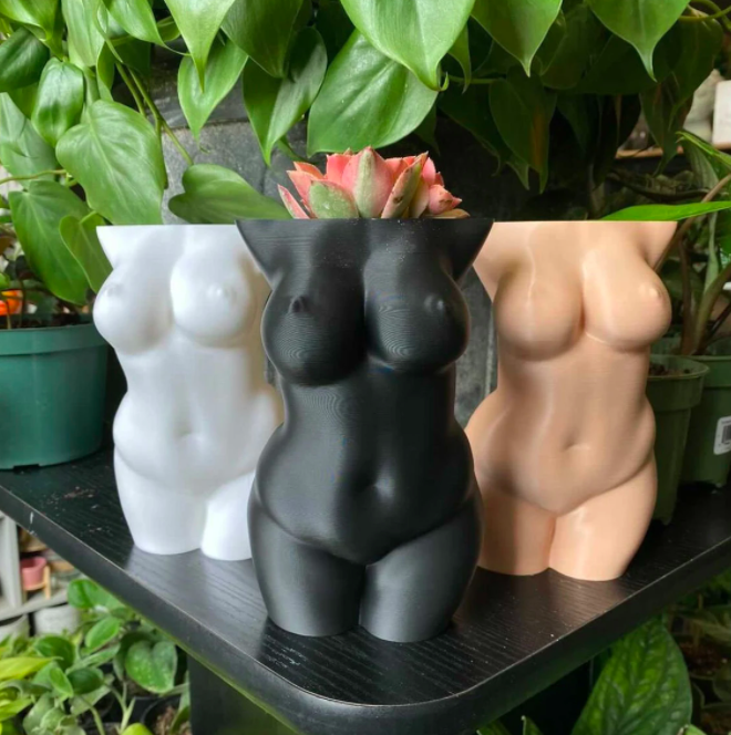 a trio of planters shaped like the naked female body