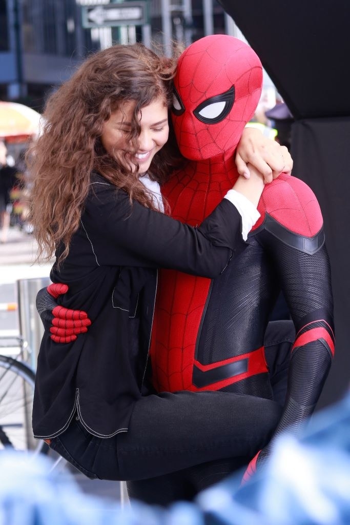 Tom as Spider-Man holding onto Zendaya as MJ