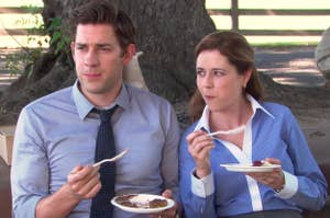 Jim and Pam from The Office sitting down and eating pie