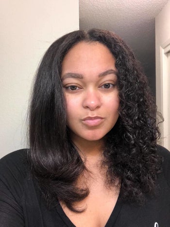 Reviewer who has straightened half of their tight curly hair with the hot air brush