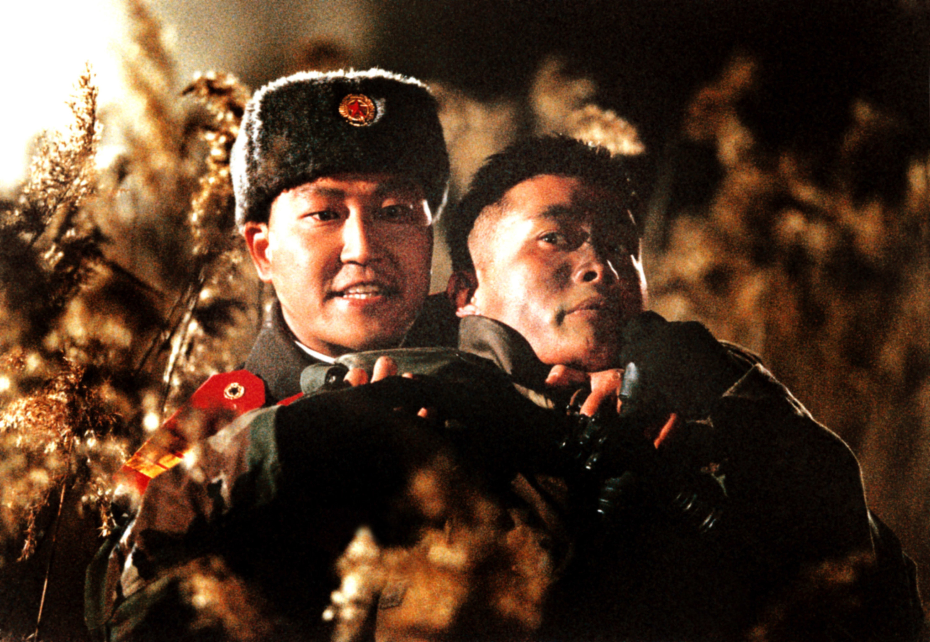 A North Korean soldier holds a South Korean soldier hostage