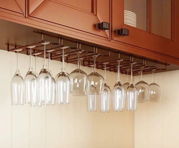 A set of wine glasses hanging from rack