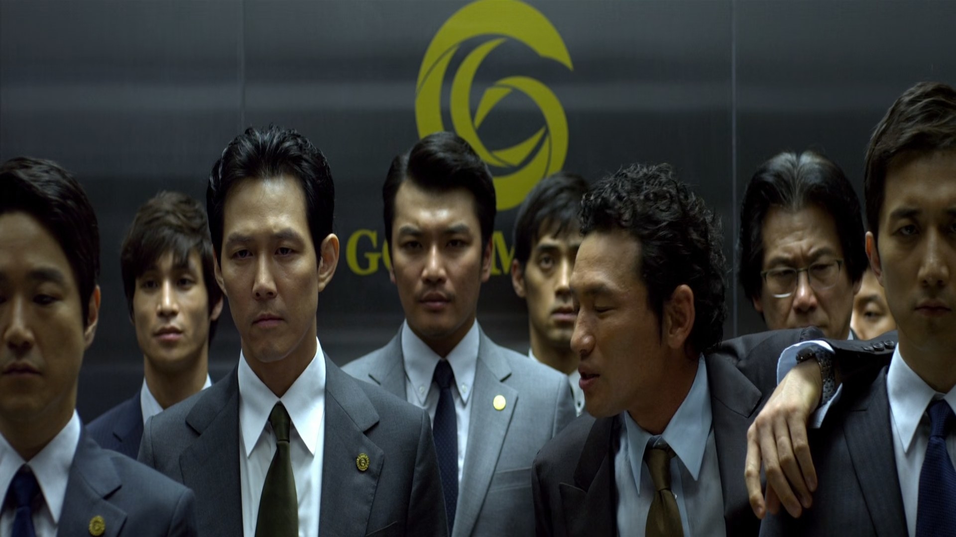 A group of men standing in an elevator.