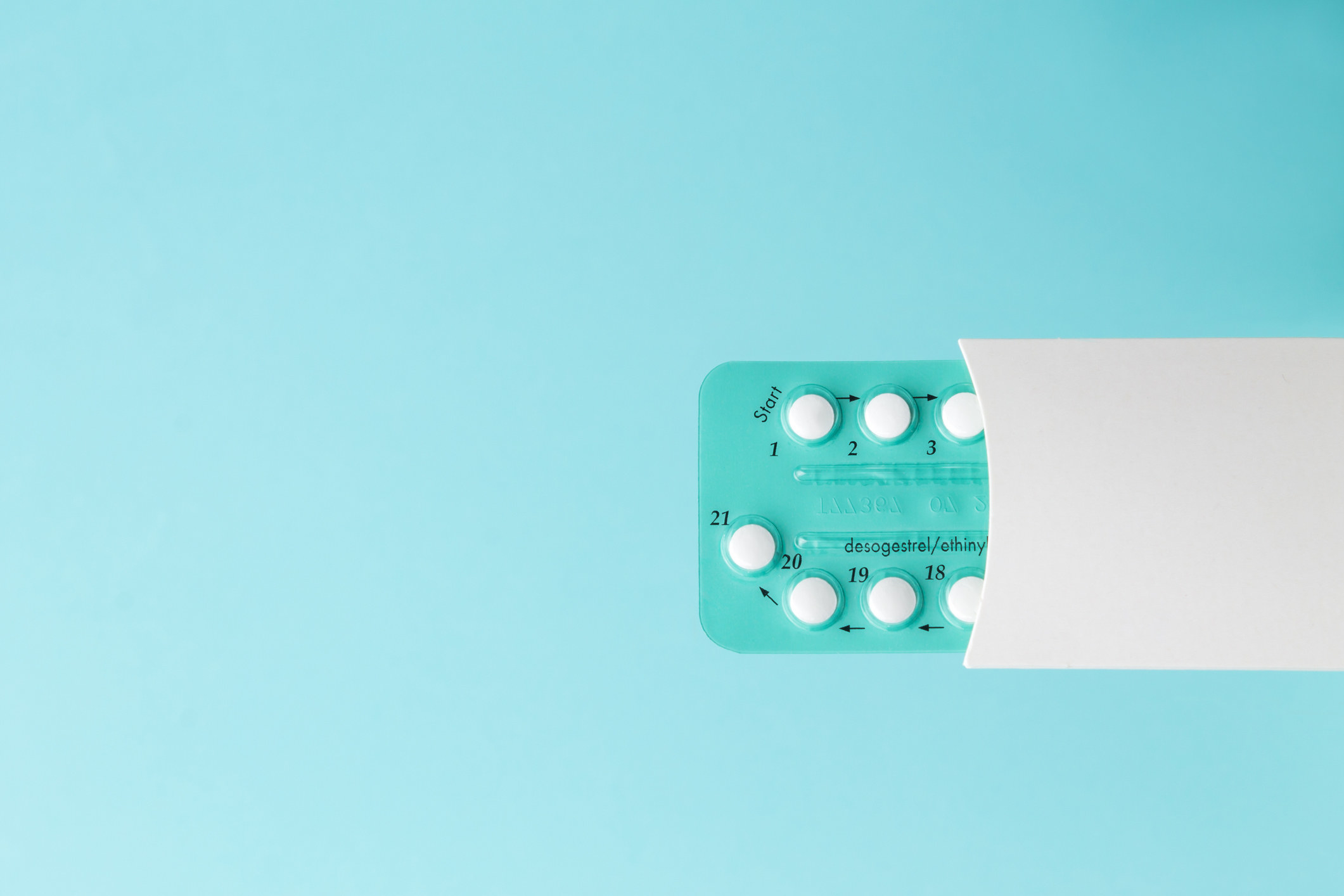Birth control pills on a blue background