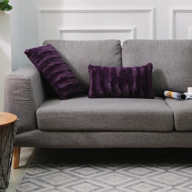 Purple pillows on gray couch