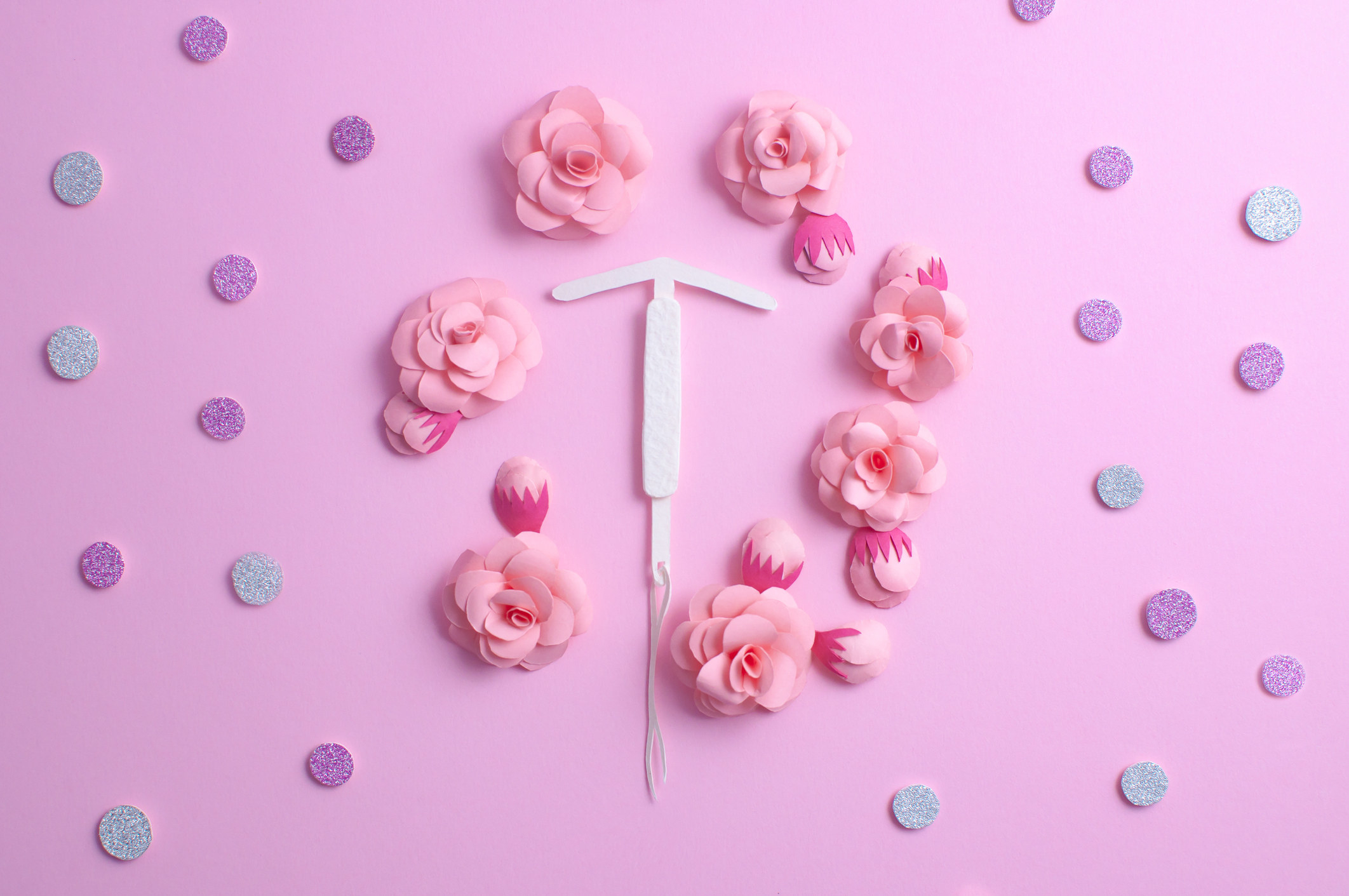 Stock image of an IUD with flowers surrounding it