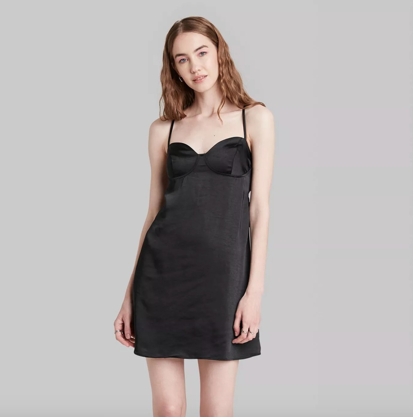 Model in a black strapped mini dress