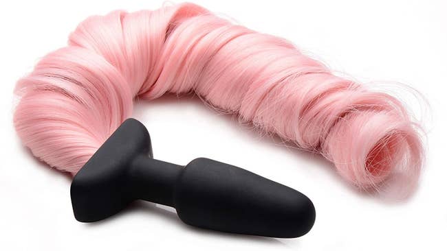 Black silicone spade-shaped butt plug attached to pink synthetic tail