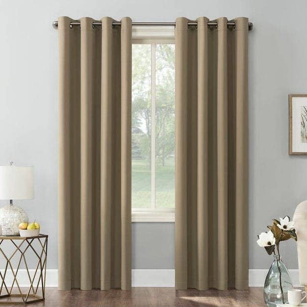 A set of tan curtains in home