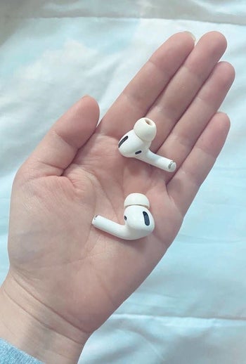 buzzfeed editor emma lord holding the airpods pro headphones in her hand