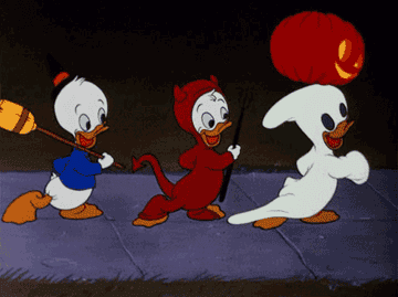 Three animated ducks in a row walk with Halloween costumes on