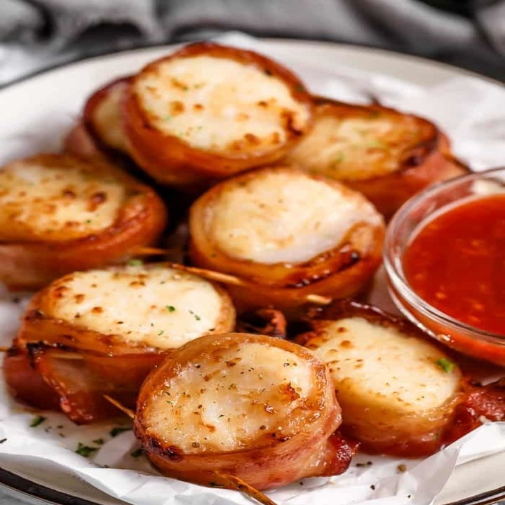 A plate of bacon wrapped scallops.