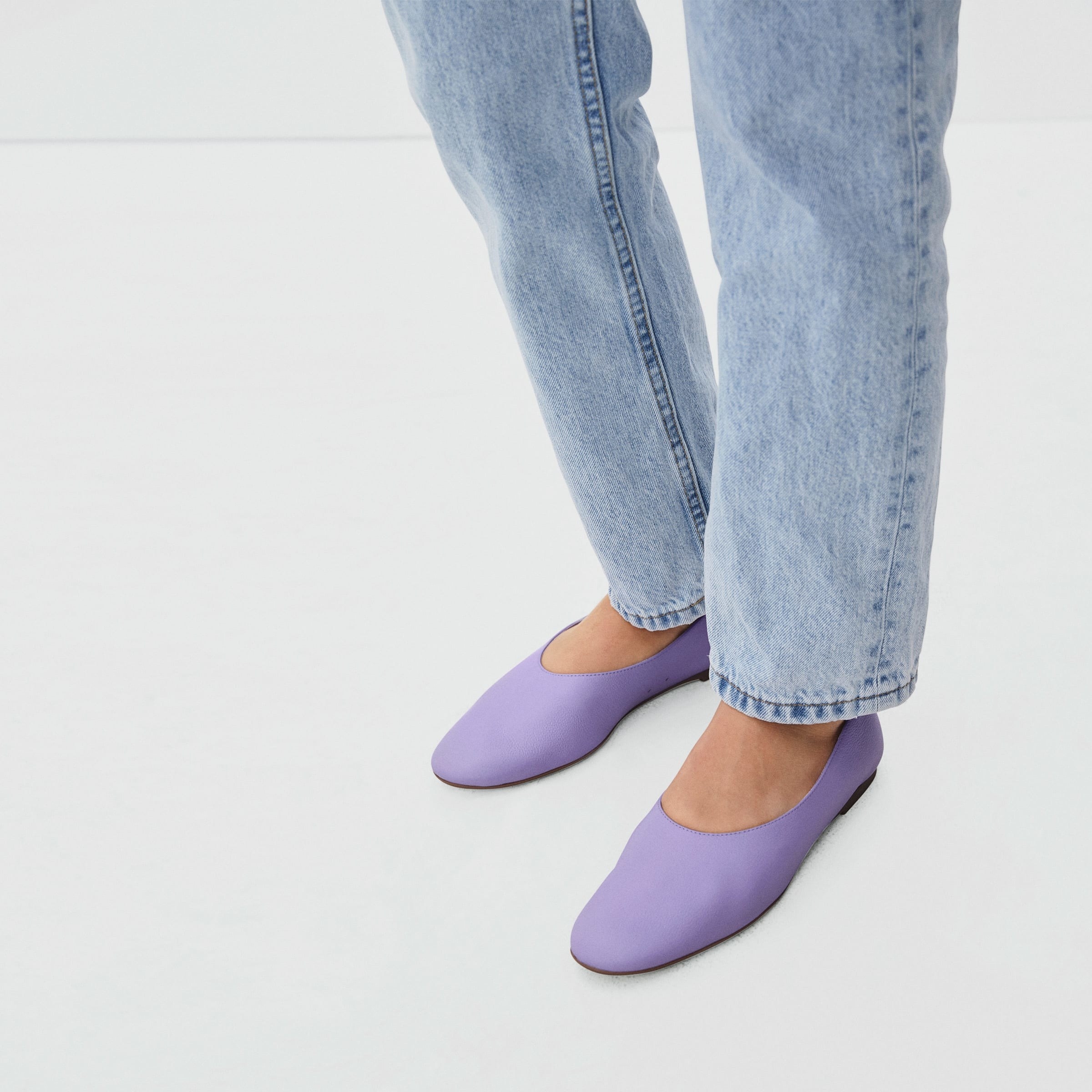 Model wearing the flats in purple showing off the rounded toe