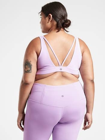 Model wearing purple Exhale sports bra