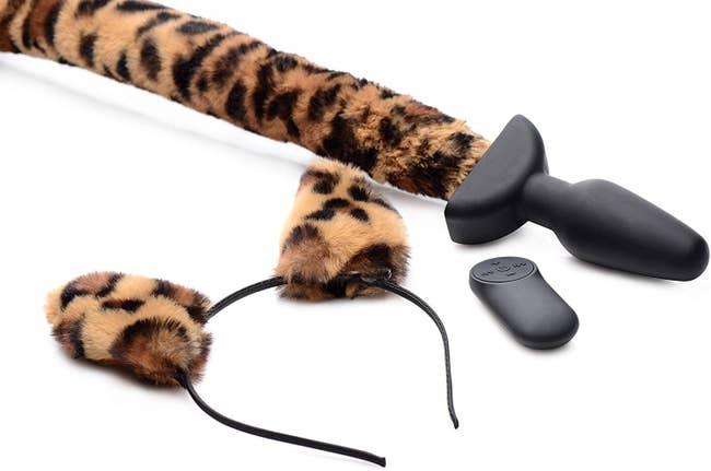 Black silicone plug attached to leopard print tail and matching leopard ear headband