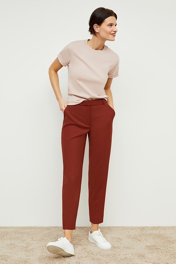 model wearing the ankle-length pants in red