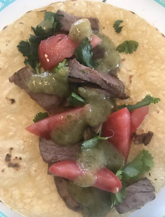 Reviewer image of a taco with the hot sauce on it
