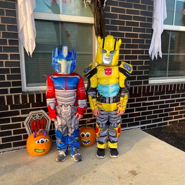 A reviewer's photo of her two kids as Optimus Prime and Bumblebee
