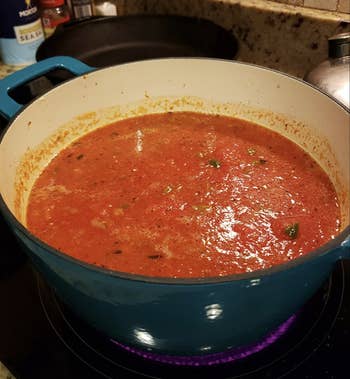 A reviewer's pot full of tomato soup that was blended with this immersion blender