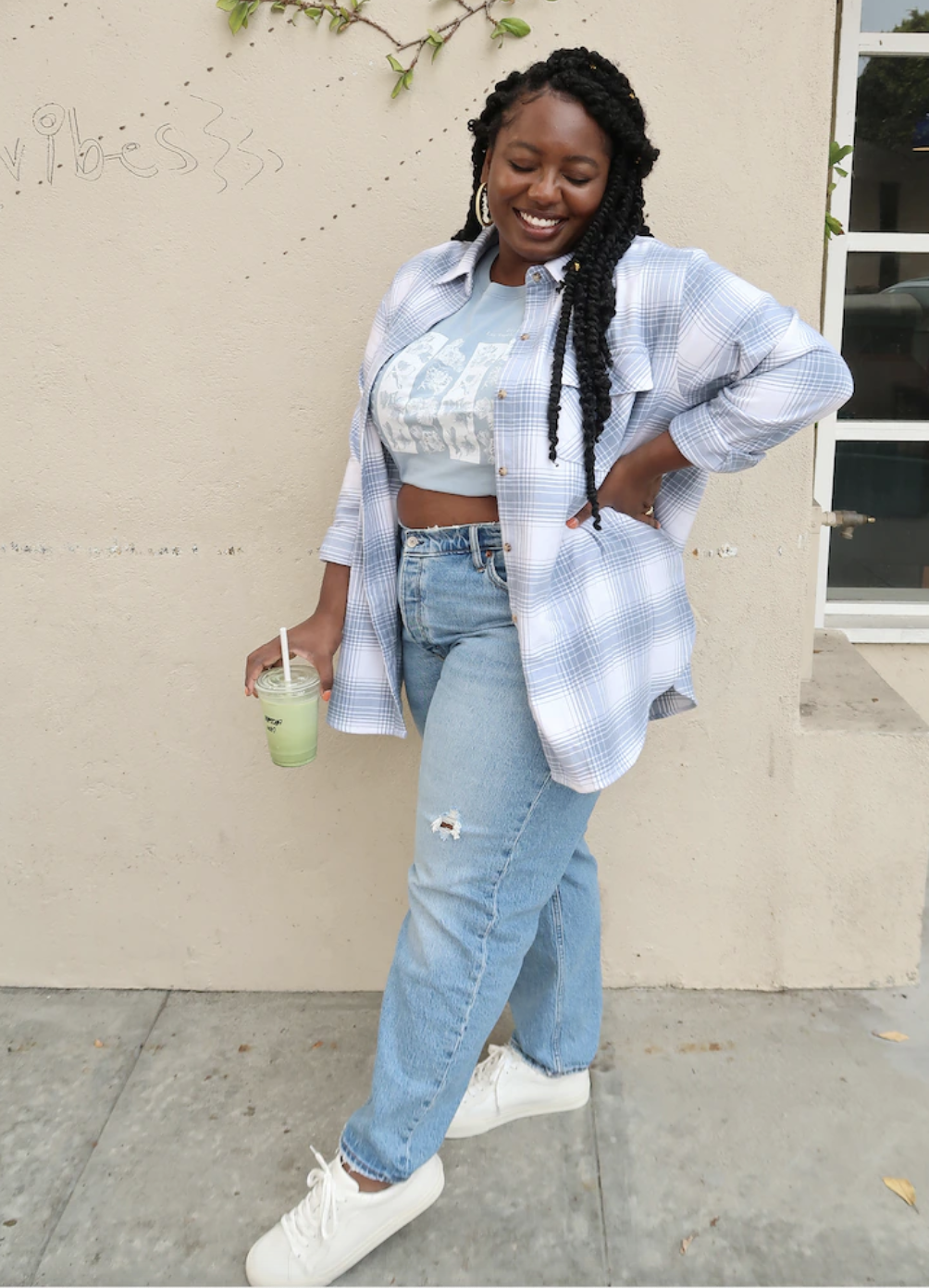 a model in a light blue and white flannel shirt