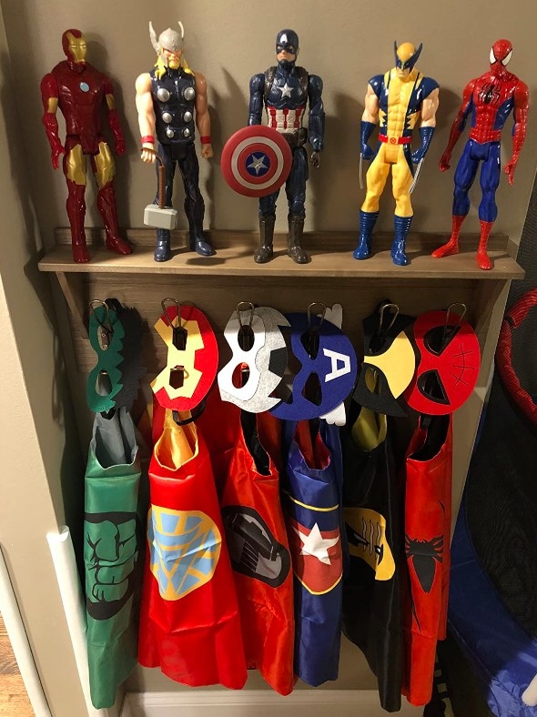 A reviewer's photo of the masks and capes hanging beneath action figures