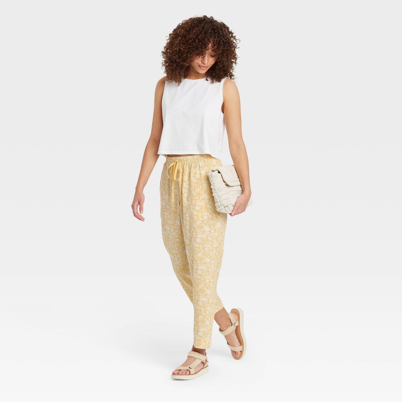 Model wearing the gold floral high-rise linen lounge pants