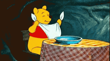 Winnie the Pooh settling in for a meal