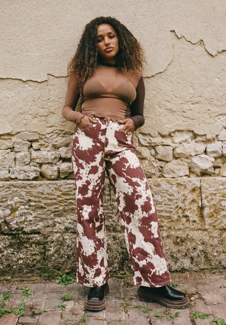 model wearing brown and white printed jeans