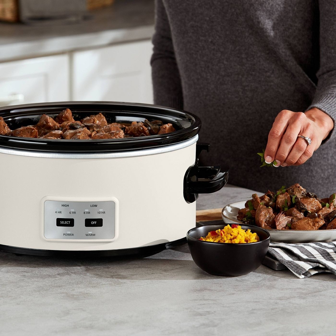 a model making stew in the white slow cooker