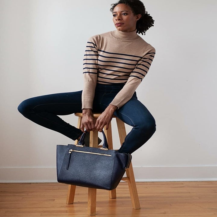 Reviewer wearing the tan and black striped turtleneck