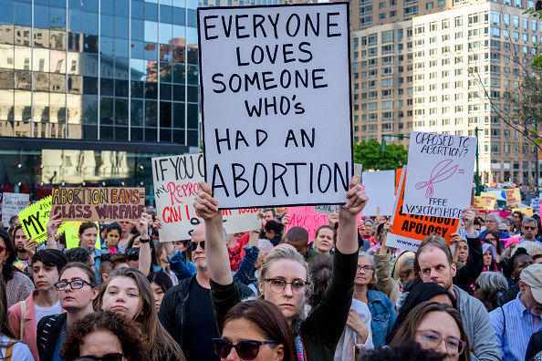 A protest sign that says &quot;everyone loves someone who&#x27;s had an abortion&quot;