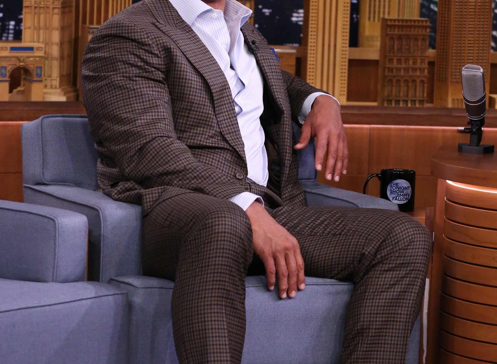 Dwayne laughs while on set at a night show.
