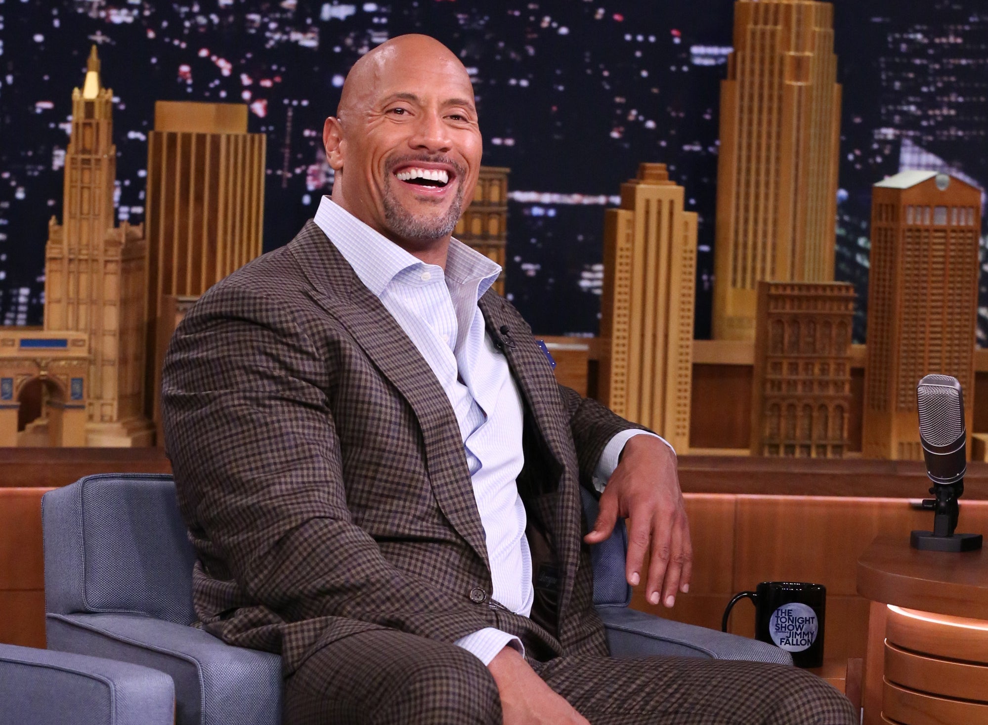 Dwayne laughs while on set at a night show.