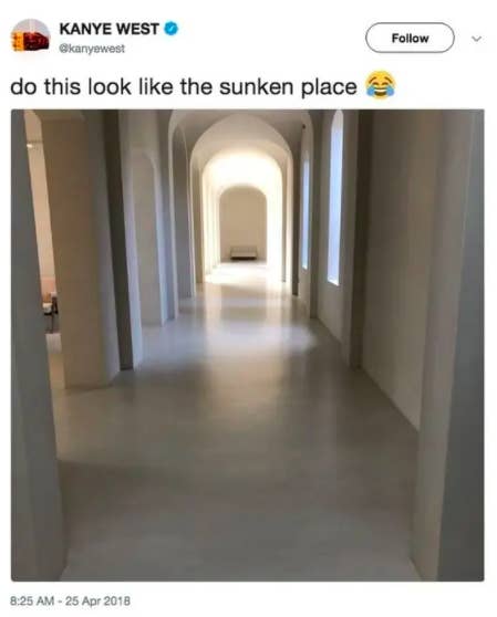 A long empty hallway in the home that features several arches