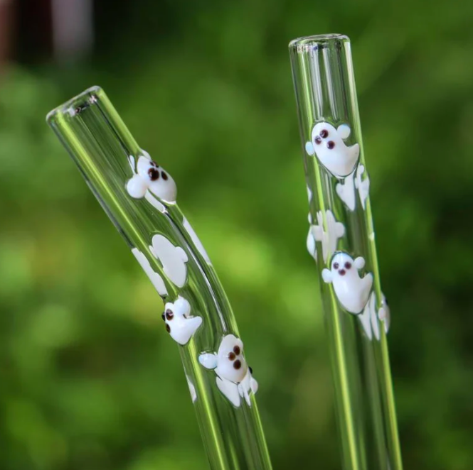 a pair of glass straws with hand-blown ghost designs on them