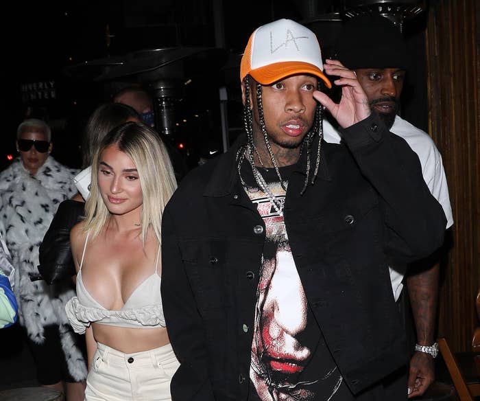 Tyga and Camaryn exit an event