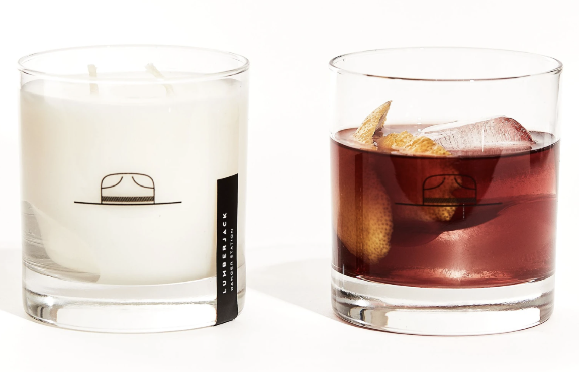 The candle is shown and a glass with whisky in it is as well