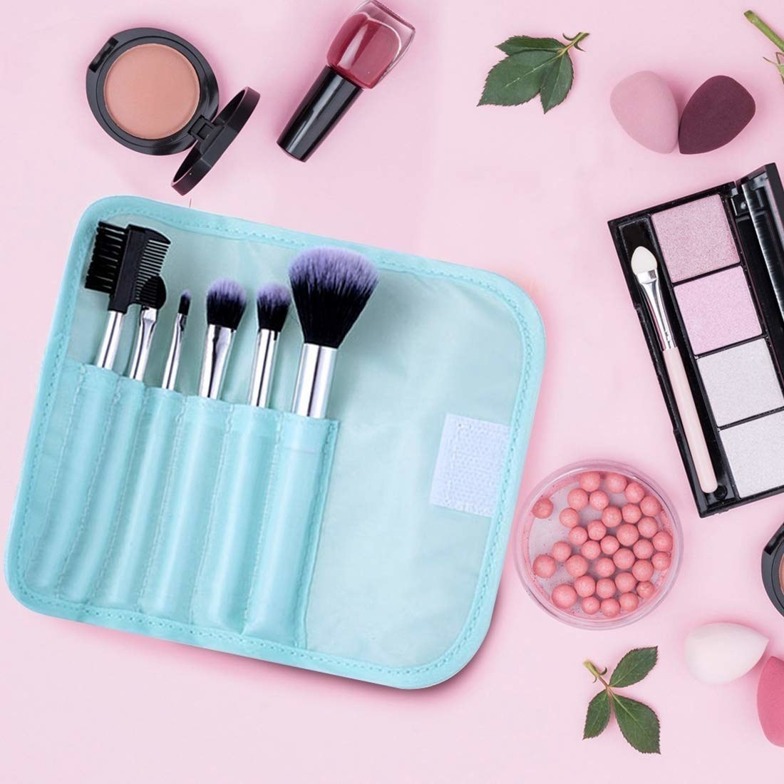 A blue kit with makeup brushes in it