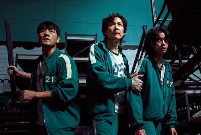 L-R: Sang-woo, Gi-hun and Sae-byeok standing together in Squid Game