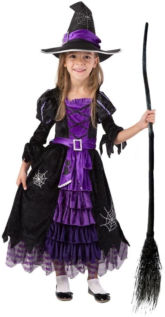 Model wearing the witch dress with hat and broom
